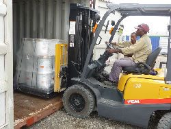 Local workers unload shipment of materials sent from the UK.