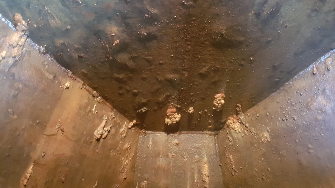  Rusty and leaking galvanised steel cold water tank. After treatment and being made watertight again. CWT Repair and lining service Specialist Coatings (GB) Ltd.