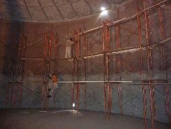 Scaffolding inside tank and corroded walls before surface preparation.
