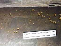 Deep pit corrosion craters in floor of galvanised steel water tank number 1, before tank lining treatment